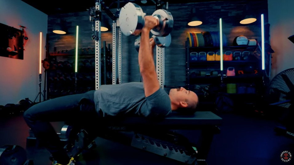 Man on a bench lifting weights